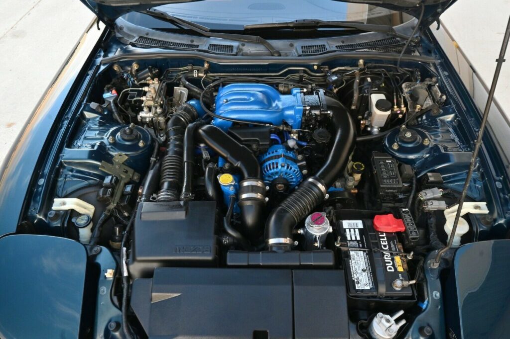 Engine bay of Montego Blue 1993 Mazda RX-7 Touring 