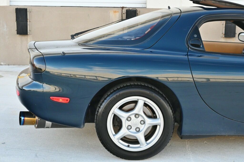 Rear side and catback exhaust of Montego Blue 1993 Mazda RX-7 Touring 