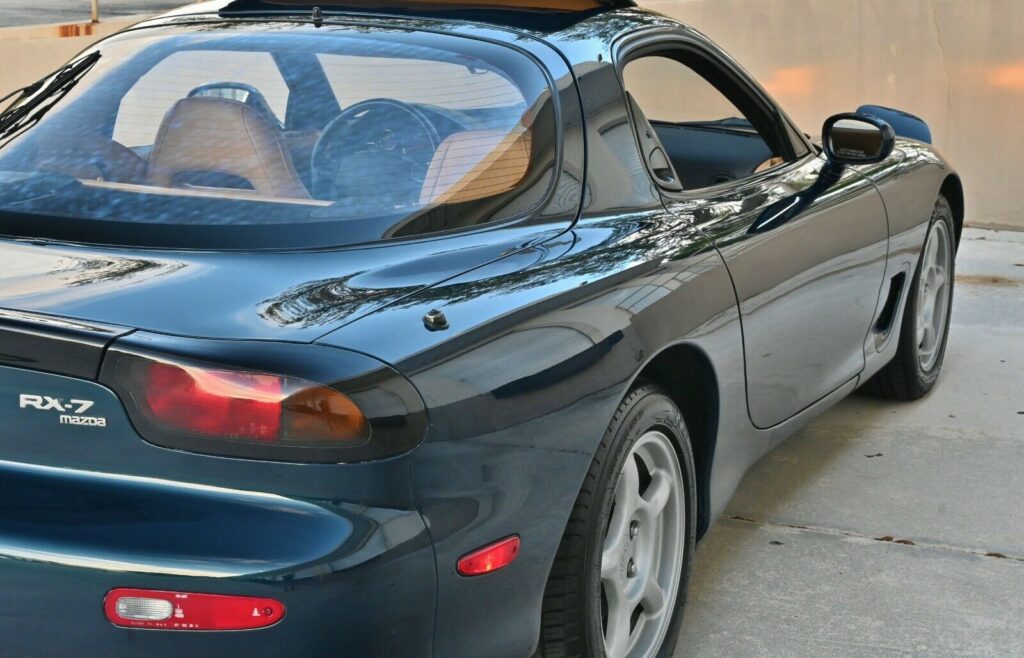 Rear passenger side view of Montego Blue 1993 Mazda RX-7 Touring 